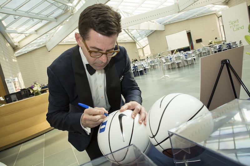 Dr. Marcu signing a basketball
