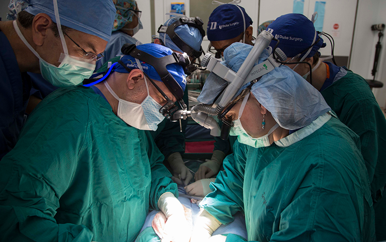 Dr. Henry Rice (left) and Dr. Debra Sudan (right) perform a conjoined twin separation. Photo by Shawn Rocco.