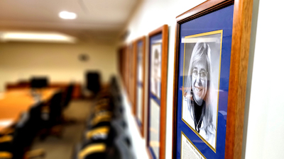 Gallery of portraits in the Master Surgeon conference room, including Debra Sudan, MD, the first woman recipient.  