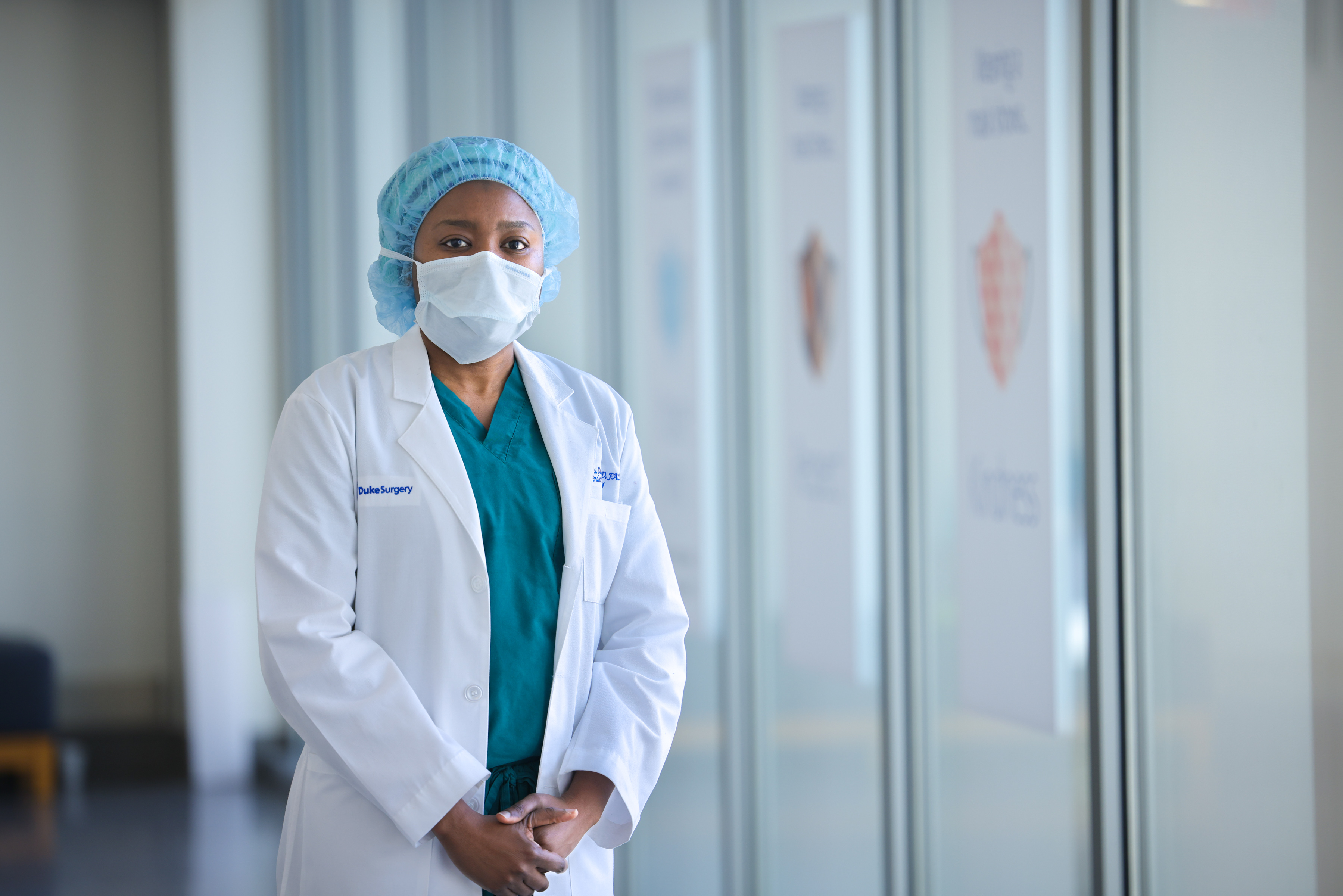 Dr. Hadiza Kazaure stands next to windows in Duke University Hospital after performing surgery
