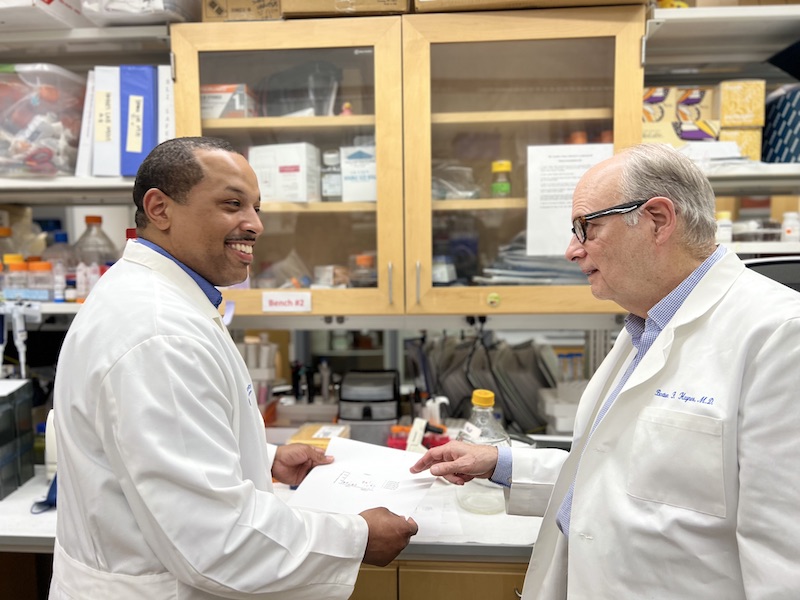 Doctors Saunders and Haynes Consulting in a lab