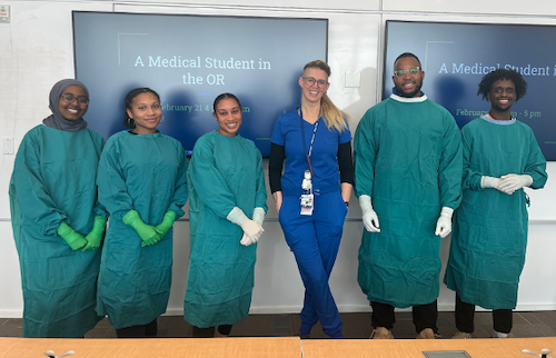 Group of medical students in surgical scrubs pose together