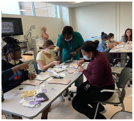 Group of students performing surgical techniques in a workshop