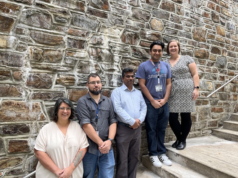 Lab members standing on a staircase