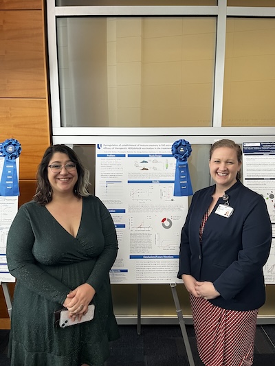 Women in front of research poster