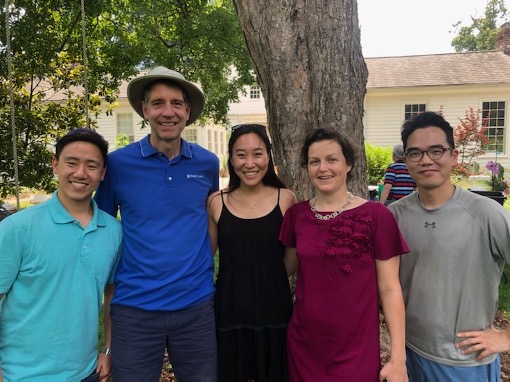 Group of people in front of a tree