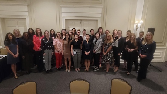 A group of residents and faculty gather for a group photo 