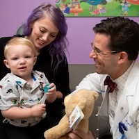 Dr. Marcus with cleft lip patient and woman