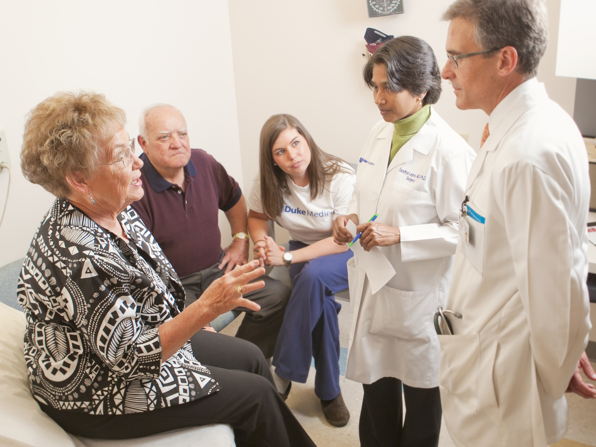 Photo of Dr. Lagoo-Deenadayalan and colleague speaking with a patient