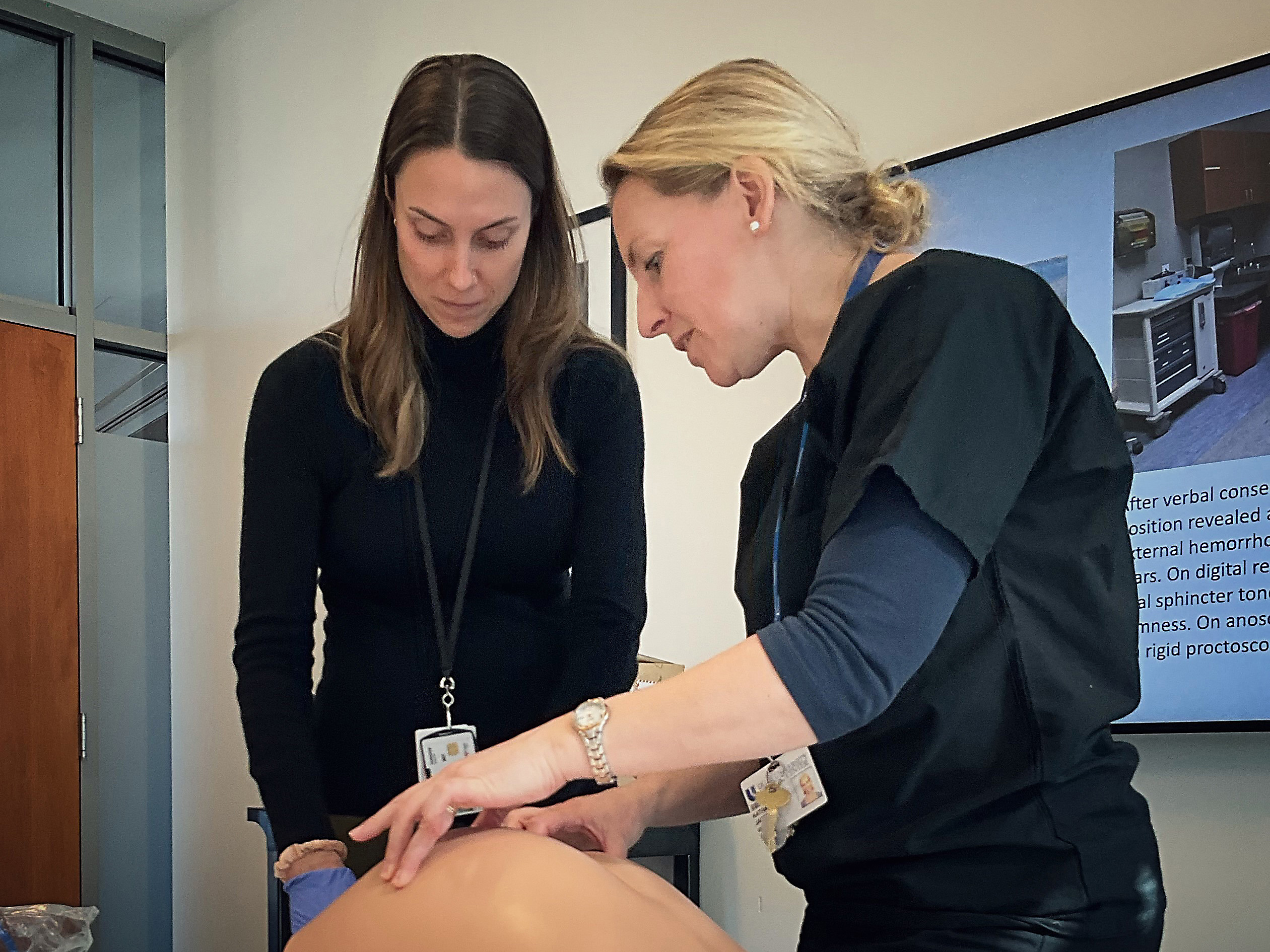 Photo of Dr. Louise Jackson working with an intern in the simulation lab