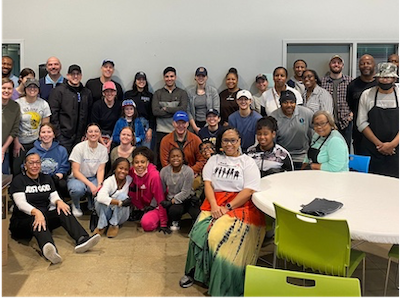 A group of people gather for a group photo at a day of community service