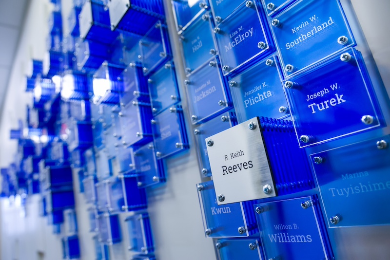 A close-up of some of the tiles on the Grant Wall display, mostly blue, but a silver tile stack reading "R. Keith Reeves" is most prominent