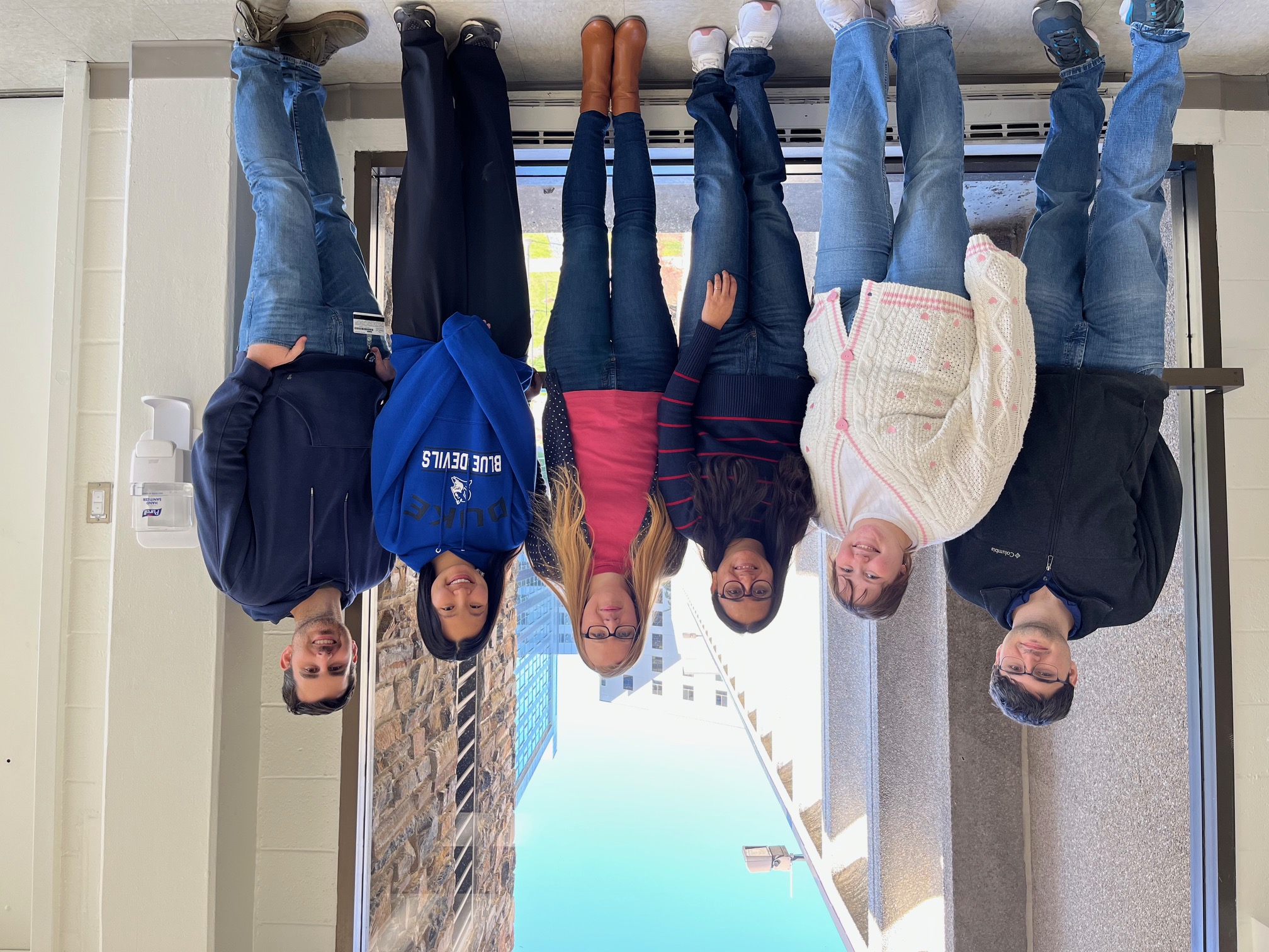 Five individuals post for a photo together