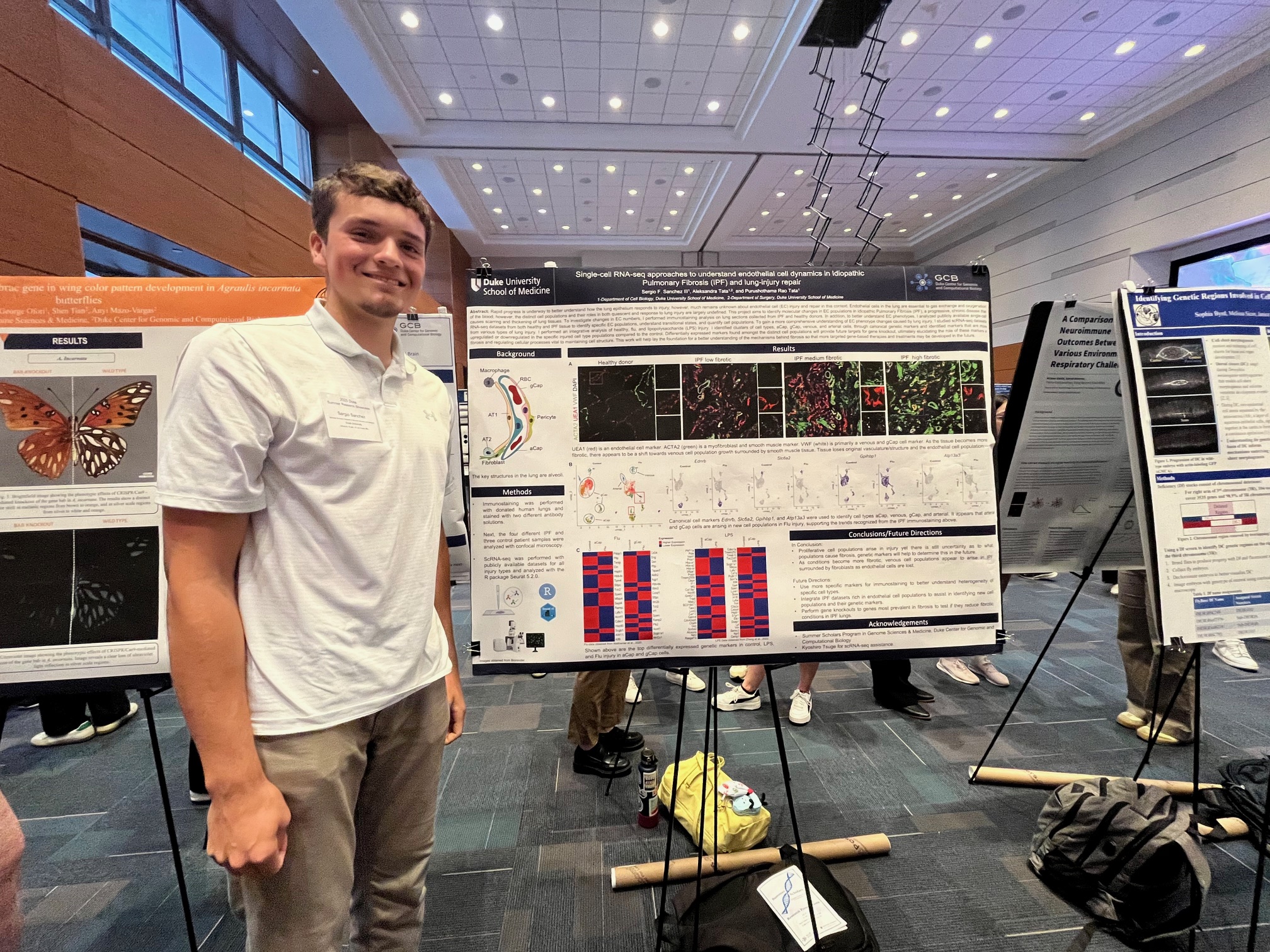 A man stands in front of a scientific research poster 