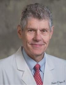 Professional headshot photo of Dr. Theodore Pappas wearing his white physician's coat