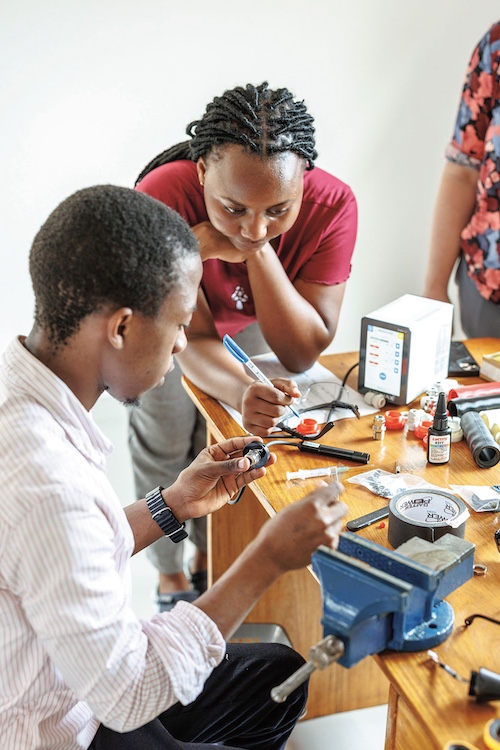 Kato Hussein Wabbi assembles a KeyScope as Samantha Keshara watches.