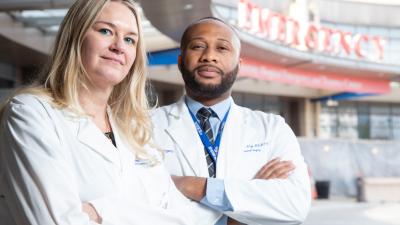 Dr. Krista Haines and Dr. Anthony Eze stand outside of the Duke Emergency Department.