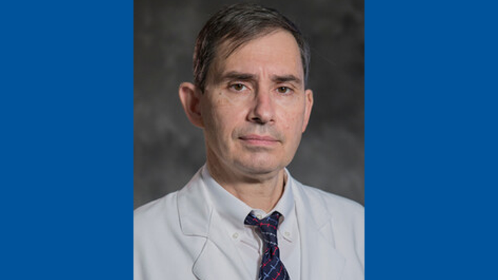 Hero image of Dr. Carmelo Milano against a blue background