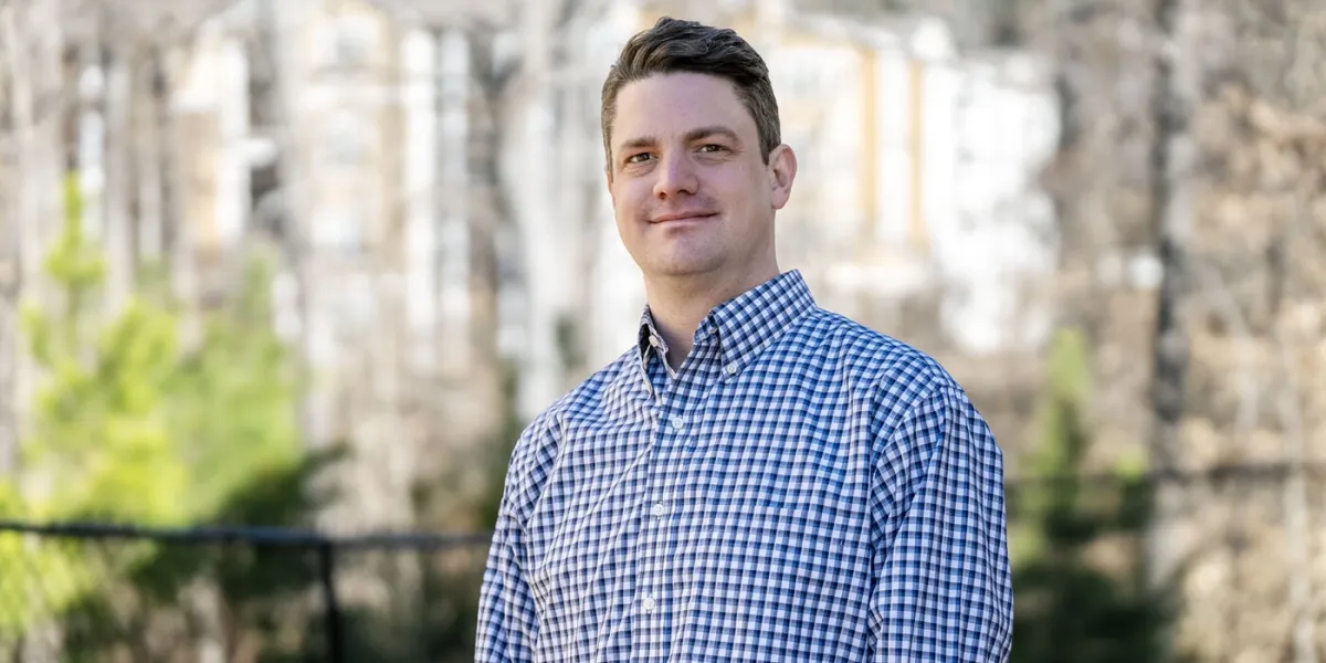 Chris Biggar stands outside his home in Durham, NC.