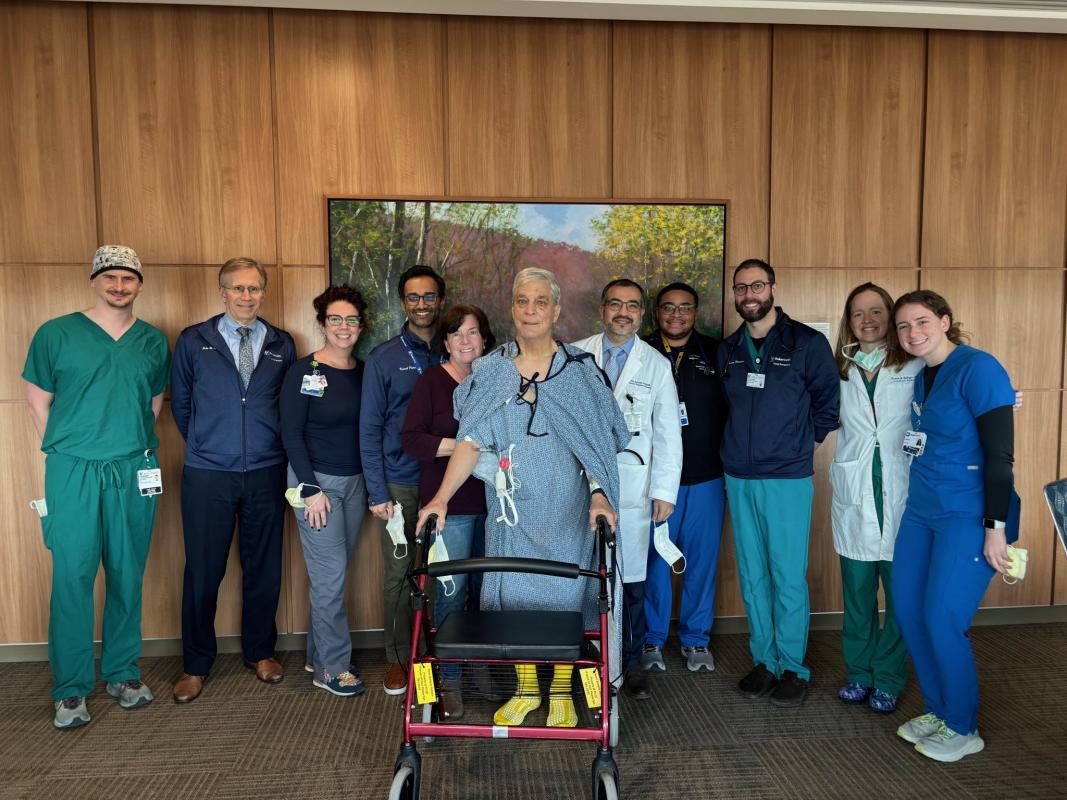 A patient stands with his team of physicians after undergoing a robotic lung transplant