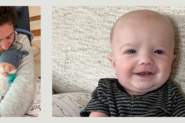 A father holds his newborn son