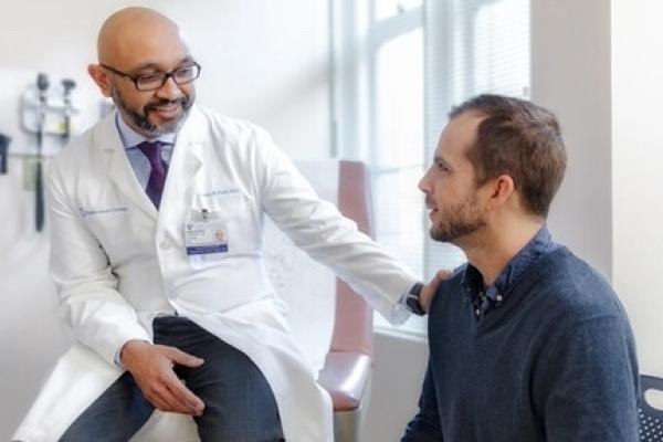 A provider meets with a patient in an exam room