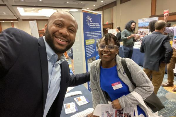 Dr. Anthony Eze, left, poses with a student at the Howard University Career Fair