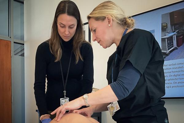 Photo of Dr. Louise Jackson working with an intern in the simulation lab
