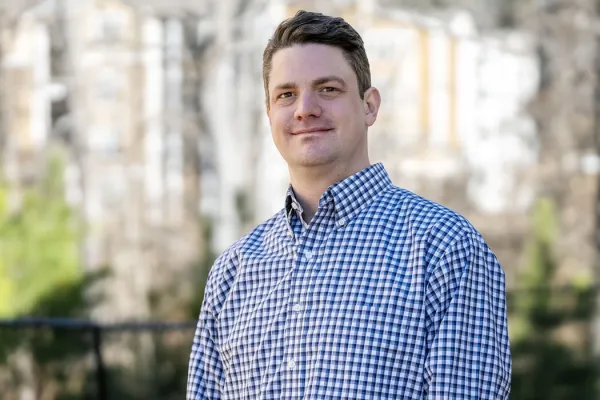 Chris Biggar stands outside his home in Durham, NC.