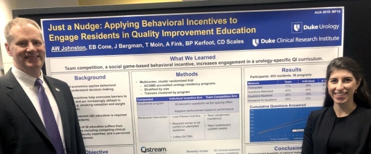 Urology researchers in front of poster