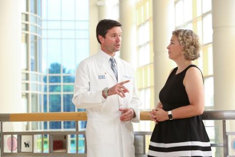Jonathan Routh, MD, Pediatric Urologist, in conversation with Deanna Adkins, MD, Pediatric Endocrinolgist and Clinic Director. By Huth Photo.