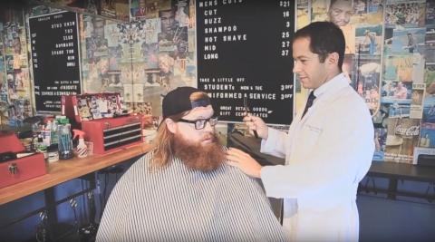 Dr. Michael Ferrandino, urologic surgeon, pretends to be a barber in a promo for Movember