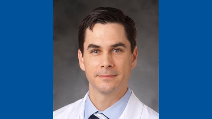 Photo of Dr. Jacob Schroder over a solid royal blue background