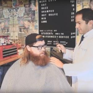 Dr. Michael Ferrandino, urologic surgeon, pretends to be a barber in a promo for Movember