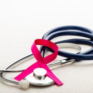 stock image of stethoscope and breast cancer awareness ribbon