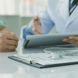 closeup of doctors' hands and charts