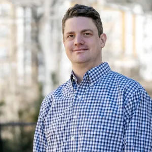 Chris Biggar stands outside his home in Durham, NC.